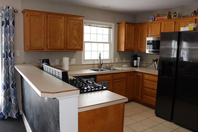 kitchen with black fridge with ice dispenser, light tile patterned flooring, sink, and kitchen peninsula