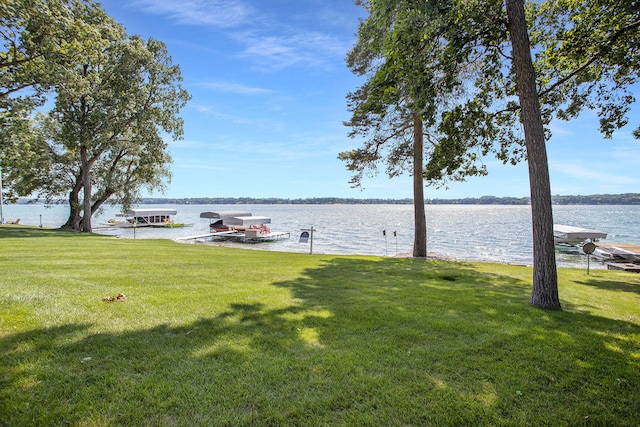 exterior space with a water view and a dock