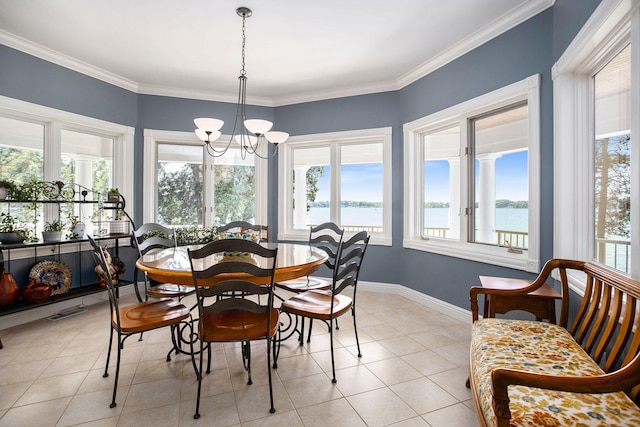 tiled dining space with crown molding, a healthy amount of sunlight, and a water view