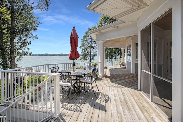 deck featuring a water view and a sunroom