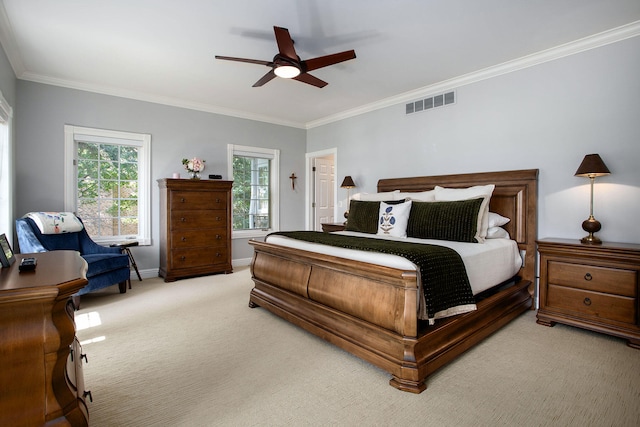 bedroom with crown molding, light colored carpet, and ceiling fan