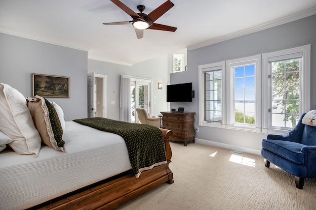 carpeted bedroom featuring ceiling fan and ornamental molding