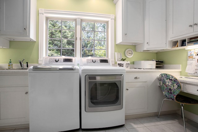 laundry room with sink, a wealth of natural light, cabinets, and washing machine and clothes dryer