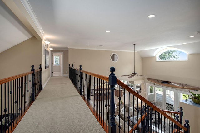 hallway featuring crown molding, light colored carpet, and vaulted ceiling