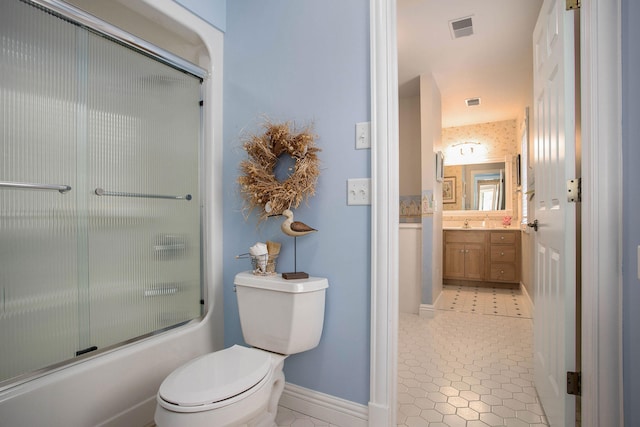 full bathroom with vanity, shower / bath combination with glass door, and toilet