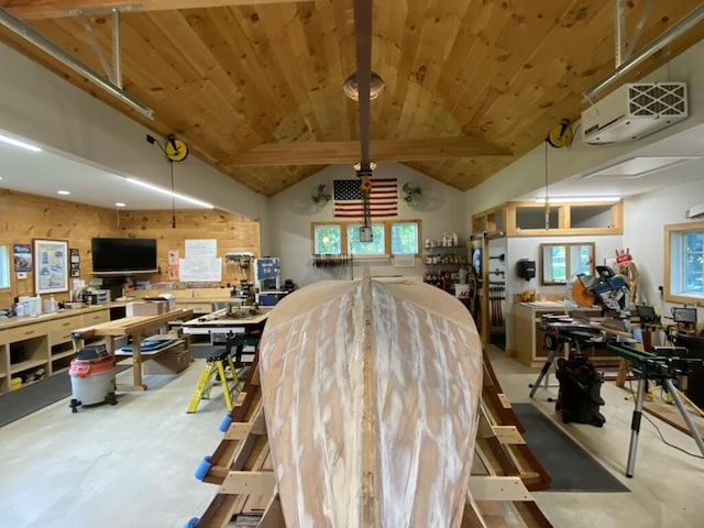 dining space featuring lofted ceiling, concrete floors, wood ceiling, and a workshop area