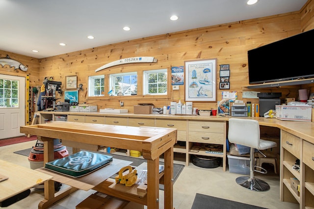 home office with wooden walls and a workshop area