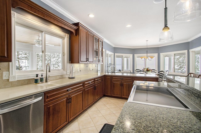 kitchen featuring a healthy amount of sunlight, sink, stainless steel dishwasher, and decorative light fixtures