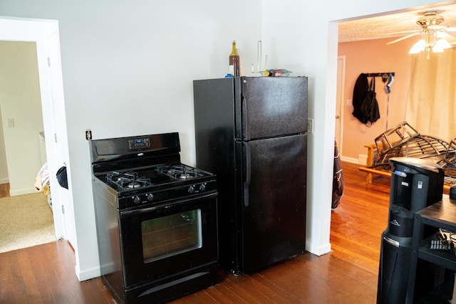 kitchen with ceiling fan, dark wood-type flooring, and black appliances