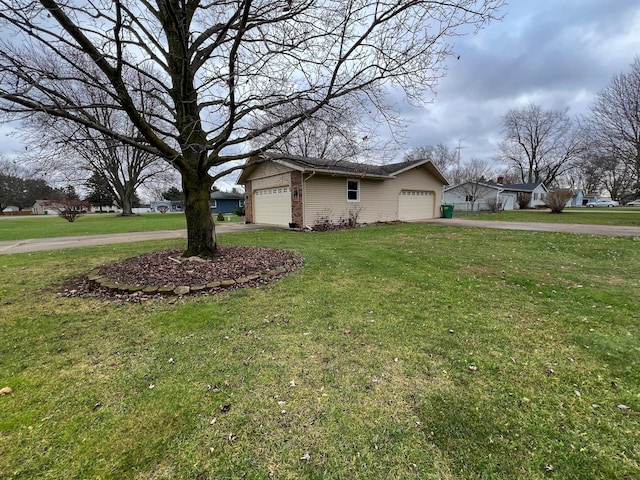 view of side of property with a yard and a garage