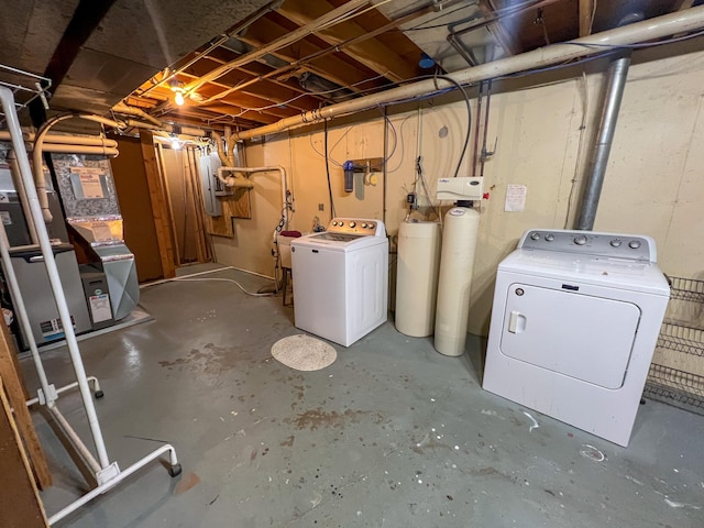 basement featuring washing machine and dryer and electric panel