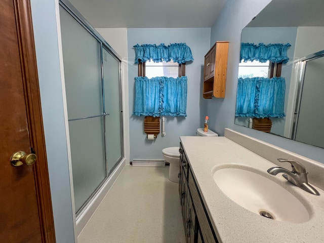 bathroom featuring a wealth of natural light, vanity, and a shower with door