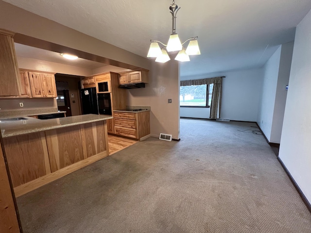 kitchen with an inviting chandelier, kitchen peninsula, pendant lighting, light colored carpet, and black appliances