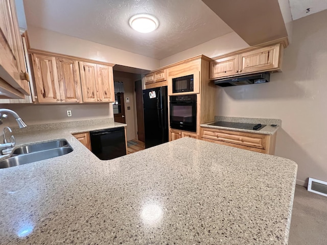 kitchen featuring light stone countertops, a textured ceiling, sink, black appliances, and light brown cabinets