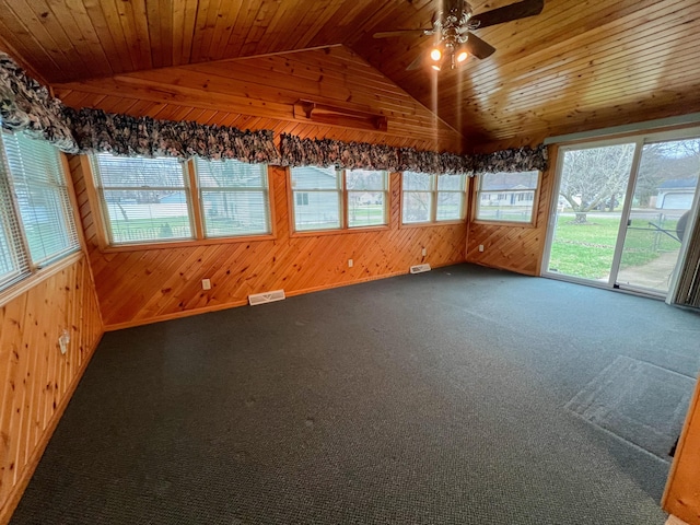 unfurnished sunroom with ceiling fan, wood ceiling, and vaulted ceiling