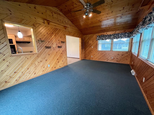 bonus room featuring carpet, wood walls, lofted ceiling, wooden ceiling, and ceiling fan