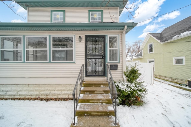 view of snow covered property entrance