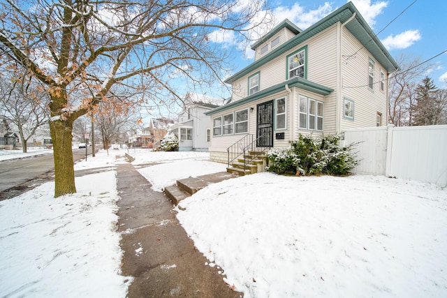 view of snow covered rear of property