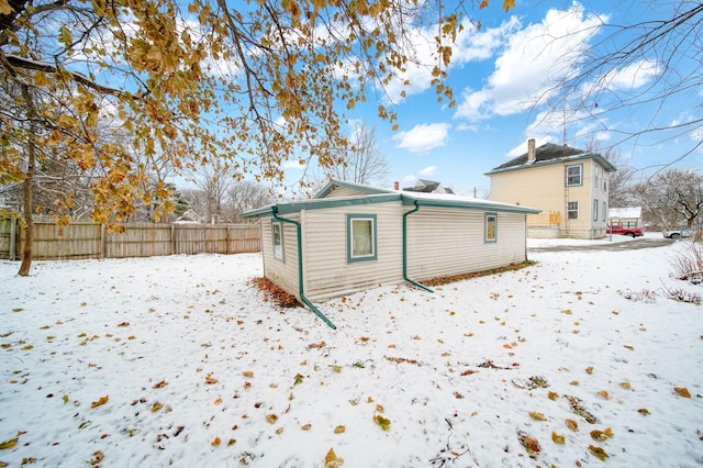 view of snow covered rear of property