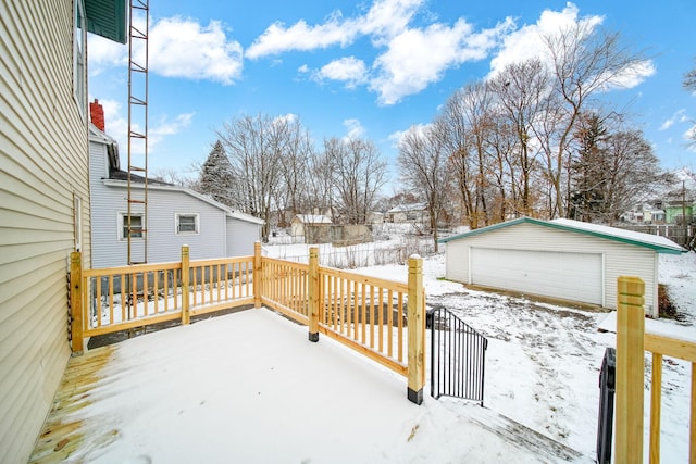 snow covered deck with an outdoor structure and a garage