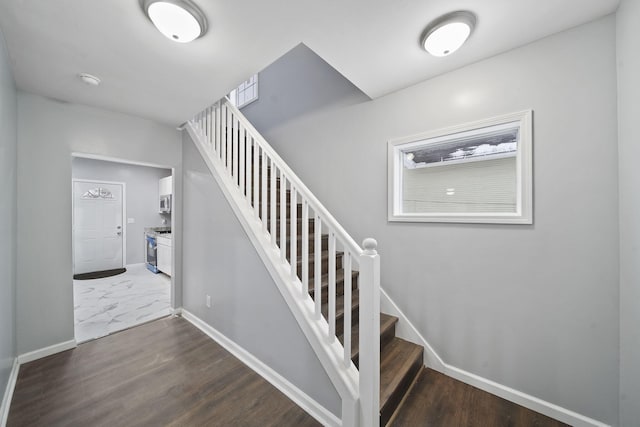 stairs featuring hardwood / wood-style flooring