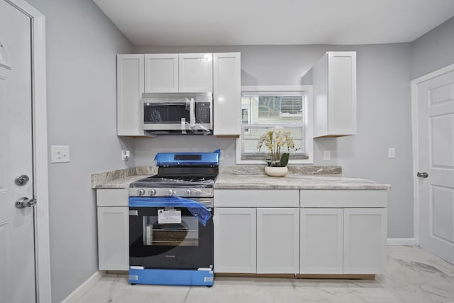 kitchen featuring white cabinets and stainless steel appliances