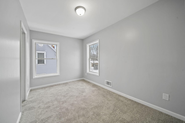 empty room featuring light carpet