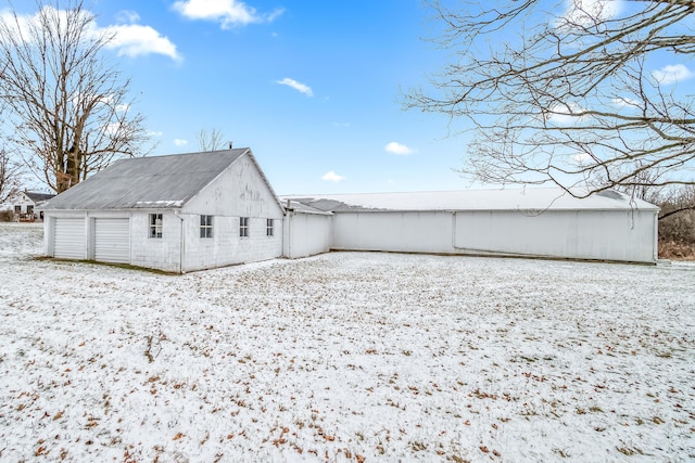 view of snow covered rear of property