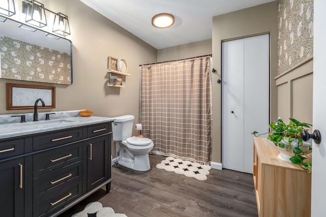 bathroom featuring hardwood / wood-style floors, vanity, and toilet