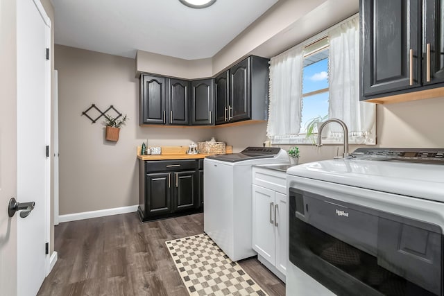 laundry area featuring dark hardwood / wood-style floors, cabinets, and independent washer and dryer