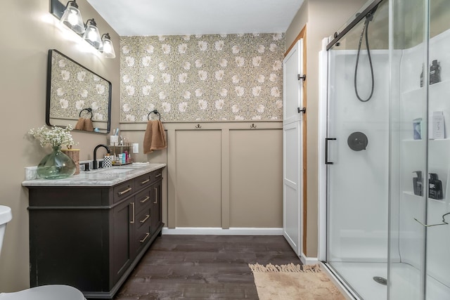 bathroom with vanity, wood-type flooring, and walk in shower