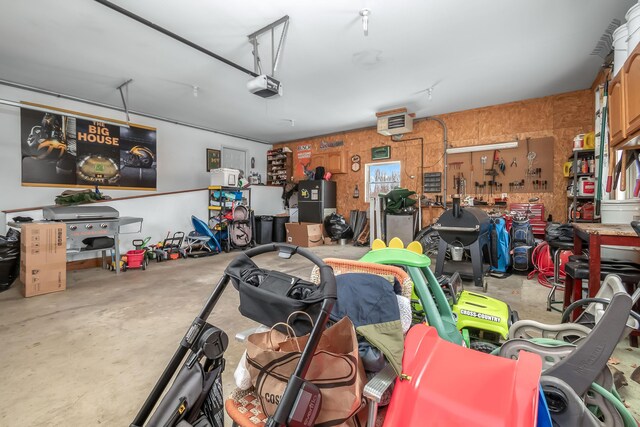 garage with a workshop area and a garage door opener