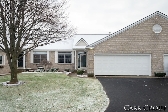 view of front of home with a front lawn and a garage