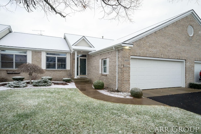 ranch-style home with a front lawn and a garage