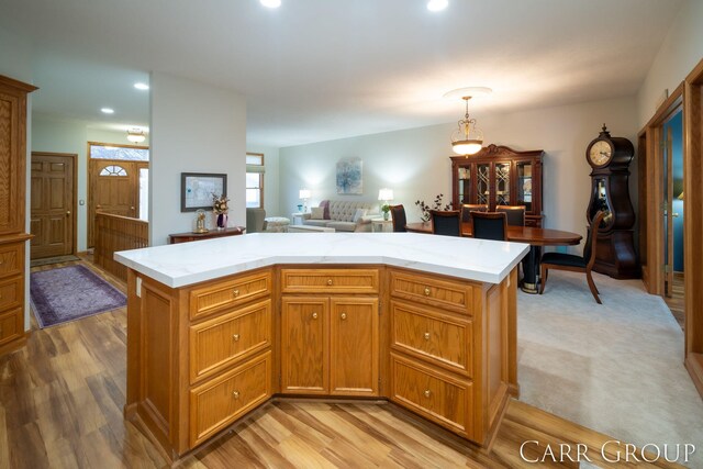 kitchen featuring a kitchen island, pendant lighting, and light hardwood / wood-style floors