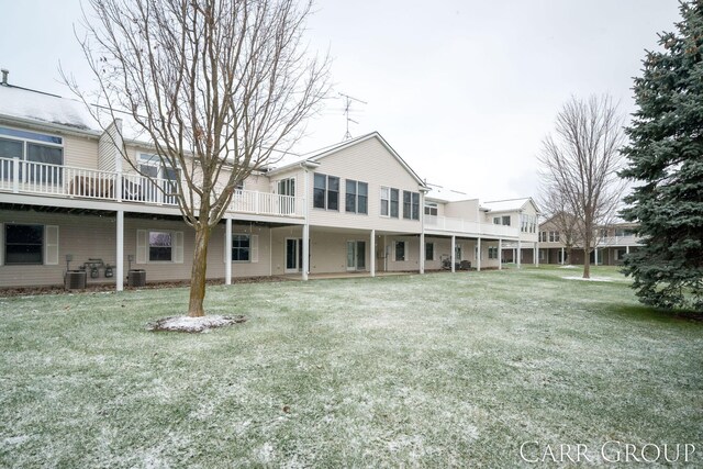 back of house featuring a yard and cooling unit