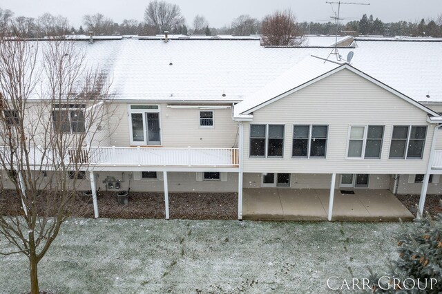 view of snow covered rear of property