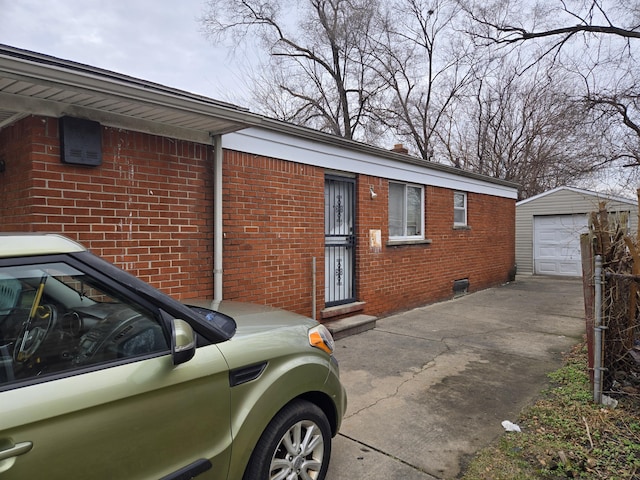 view of front of home featuring a garage and an outbuilding