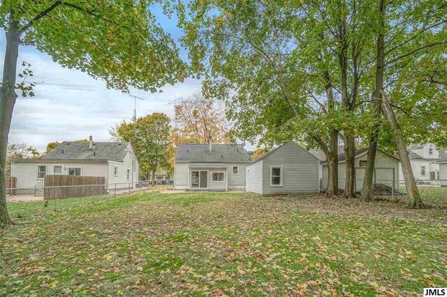 rear view of property with a yard