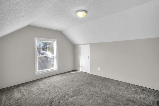 bonus room with a textured ceiling, carpet, and vaulted ceiling