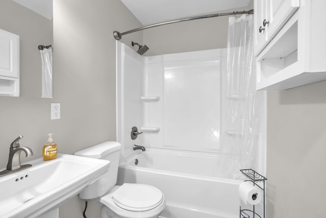 full bathroom with sink, shower / bathtub combination with curtain, and toilet