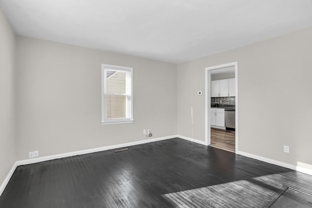 spare room with dark hardwood / wood-style flooring