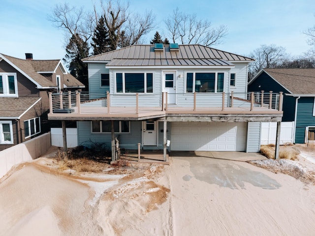 view of front of home featuring a garage and a balcony