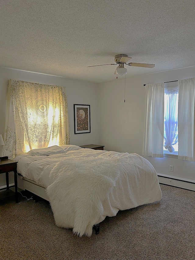 carpeted bedroom featuring ceiling fan, baseboard heating, and a textured ceiling