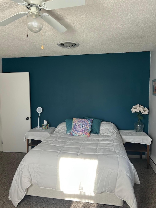 bedroom featuring a textured ceiling, ceiling fan, and carpet flooring