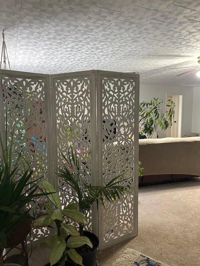 interior space featuring a textured ceiling and carpet flooring