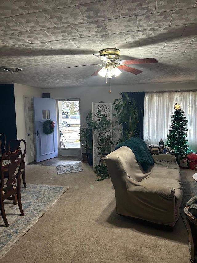 carpeted living room featuring ceiling fan