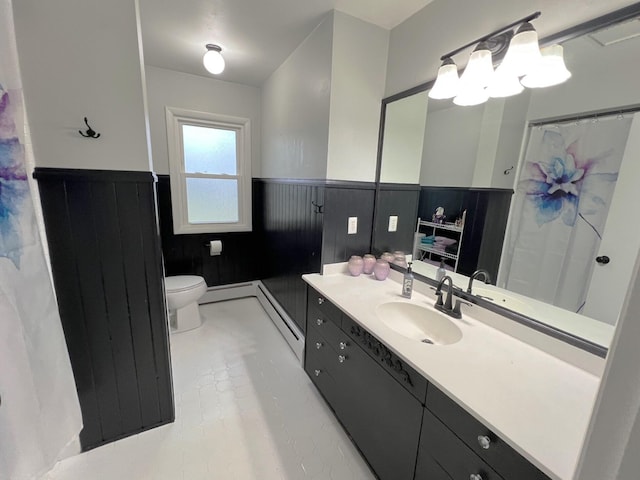 bathroom with a baseboard radiator, tile patterned floors, toilet, and vanity