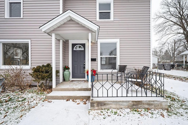 view of snow covered property entrance