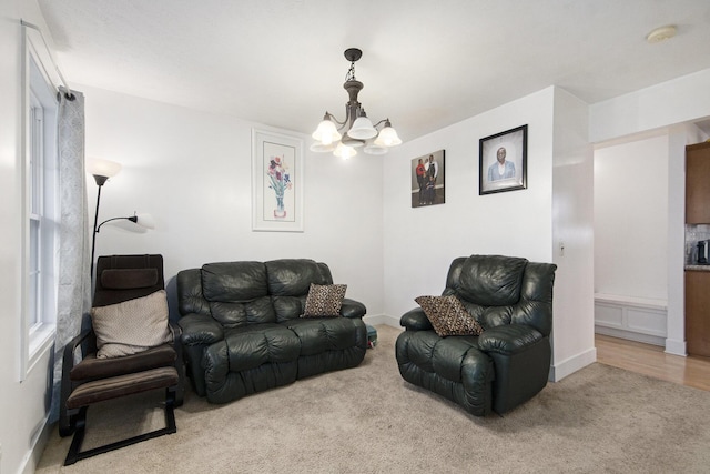 carpeted living room with an inviting chandelier